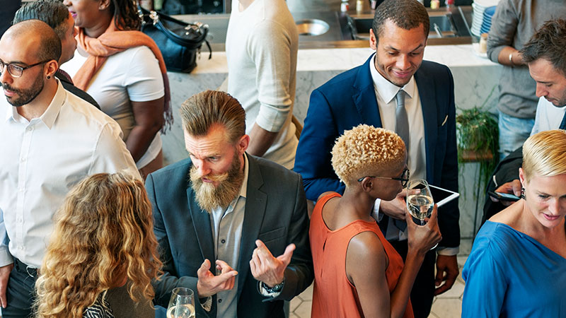 Diverse group of men and women at corporate party event
